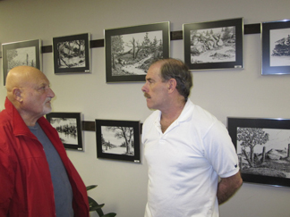 Dave Campbell (R) speaking with a visitor to his exhibit at the historic Adams Horse Stable in Saugerties, NY