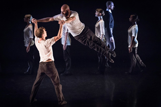 Scene from REQUIEM where Josh Christopher is supporting John-Mark Owen (in the air). With ensemble behind them.   Photo by Brian Krontz 
