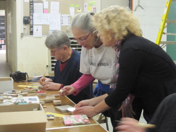 While on a press trip to Ann Arbor, Cornelia Seckel (center) is getting help from Nawal Motawi (R), owner and founder of  Motawi Tile Factory 