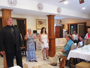 Larry Harris, Carmela Altamura, and Sydney Harris entertaining volunteers at the Altamura Center for the Arts in Roundtop, NY