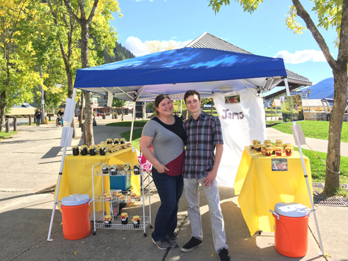 Harry Vannatta and Stephanie Nicosia outside their kiosk for Harry’s Wild Berry Preserves